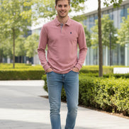 Pink long-sleeve polo shirt on a hanger with text 'Relieve Shoulder wrinkles' on a blurred background.