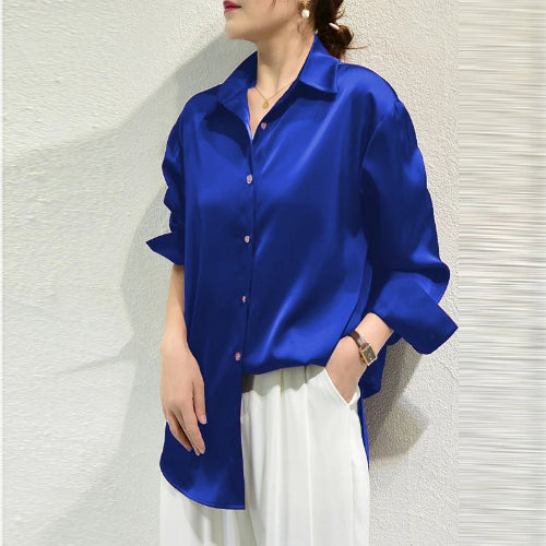 Royal blue satin blouse worn by a model, shown from the side.