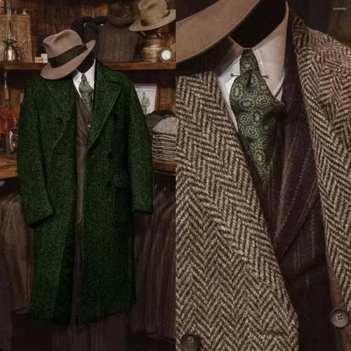 A vintage-style men's suit ensemble displayed on a mannequin in a rustic shop interior. The outfit includes a dark green textured overcoat, a brown herringbone 