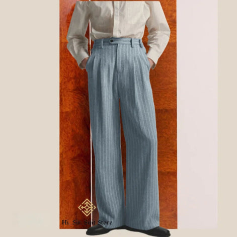Person wearing a white shirt and light blue striped pants against a wooden panel background.