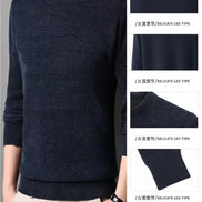 Dark blue sweater worn by a person with close-up details of the fabric.