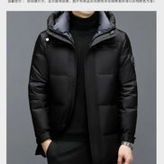 Black winter jacket worn by a person on a gray background