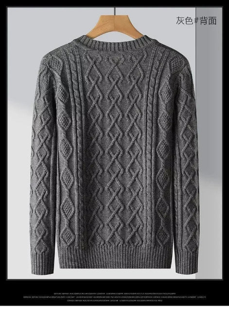Gray sweater with a diamond pattern on a hanger against a light gray background