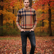 Plaid sweater with brown, red, and black pattern on a gray background
