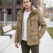 A hooded winter jacket in a warm khaki-tan color, shown open to reveal a soft fleece lining. The jacket features multiple front pockets with zippers and snaps