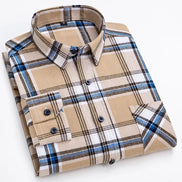 A folded long-sleeve plaid button-up shirt in beige, white, blue, and black, shown on a clean white background.