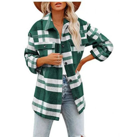 Woman wearing a dark green and white plaid shirt with jeans, against a white background.