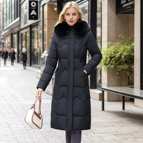 Woman wearing a black puffer coat with fur hood on a city street.