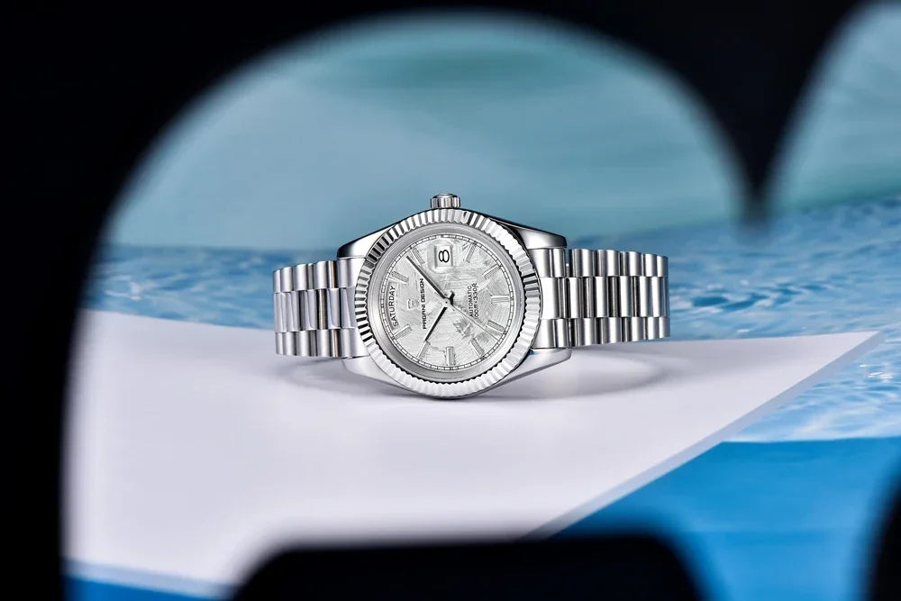 Silver watch on a blue and white fabric background