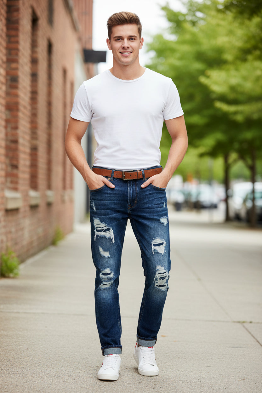 Ripped blue jeans with a brown belt on a wooden floor and cloudy sky background