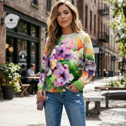 Person wearing a colorful floral sweatshirt with a blurred background