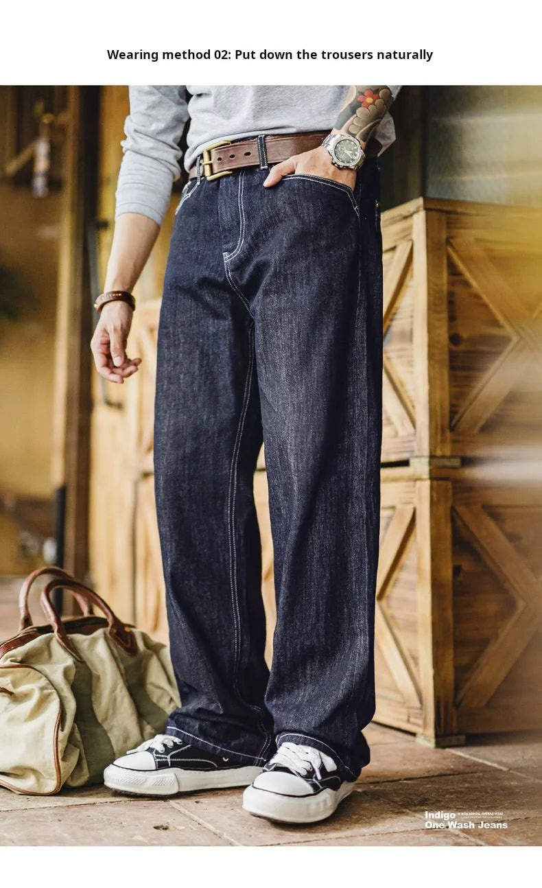 Person wearing dark blue jeans with a wooden background
