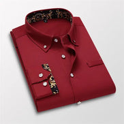 Folded red shirt with decorative cuffs on a light gray background