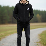 Black hoodie with beige lining on a textured beige background