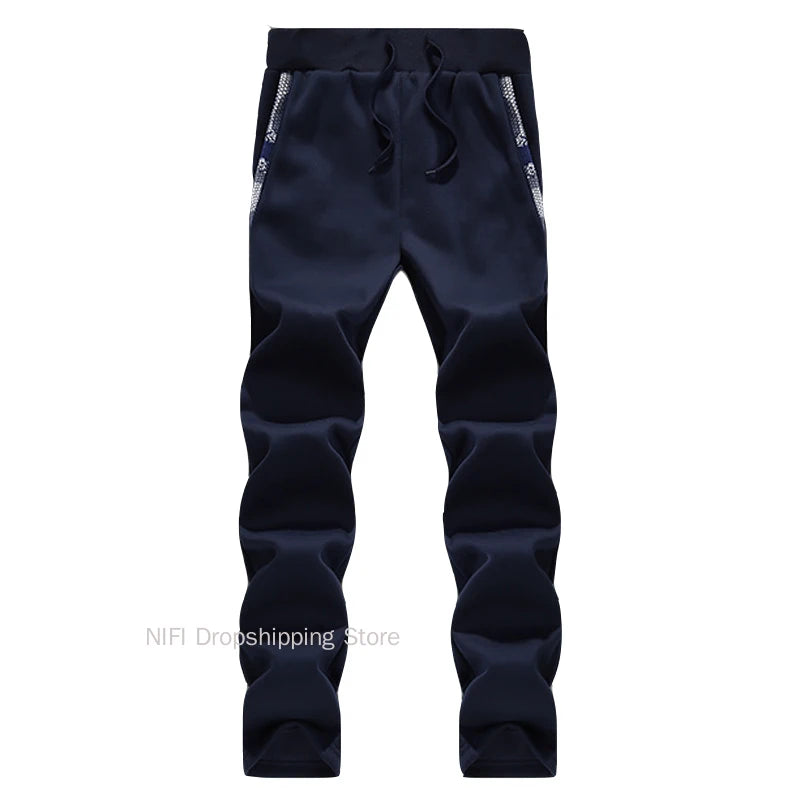 Navy blue pants with white zippers on a white background