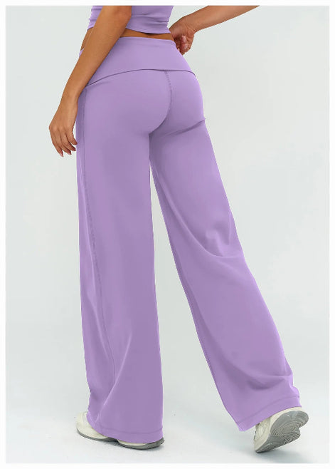 Person wearing purple high-waisted pants on a light gray background