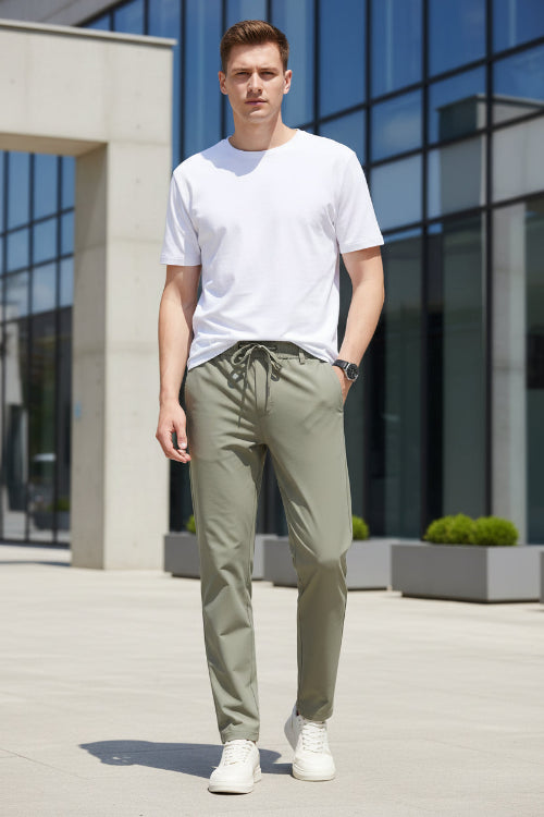 Khaki pants worn by a person on a plain background