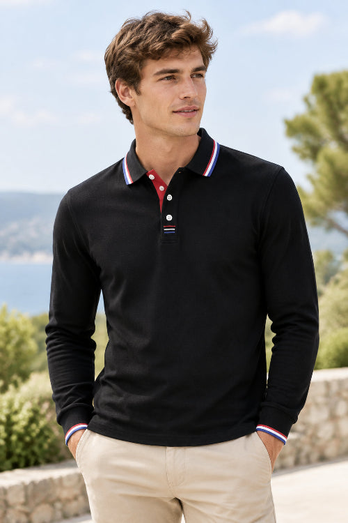 A black long-sleeve polo shirt with a classic collar, featuring red, white, and blue striped trim on the collar and cuffs, and a three-button placket.