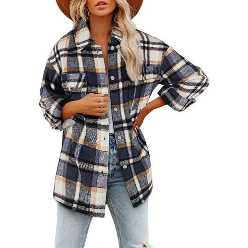 Woman wearing a navy, cream, and tan plaid shirt with jeans, against a white background.