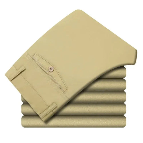 Stack of beige pants on a white background