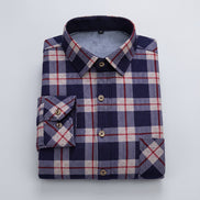A folded men's long-sleeve plaid shirt in navy, gray, and red, with a visible fleece lining 