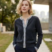 Close-up of a gray sweater with a button detail