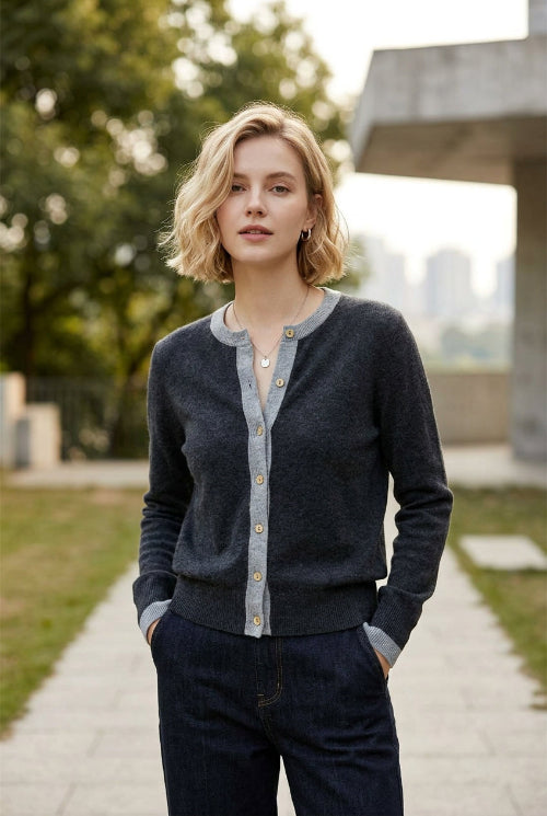 Close-up of a gray sweater with a button detail