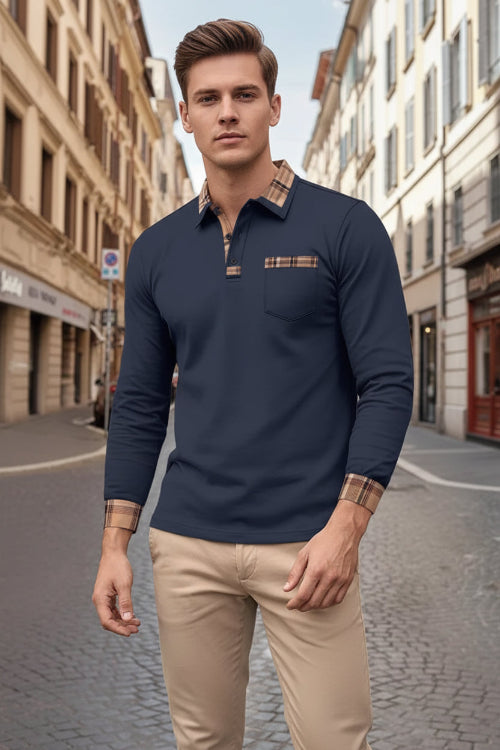 Man wearing a navy long-sleeve polo shirt with plaid accents on a city street.