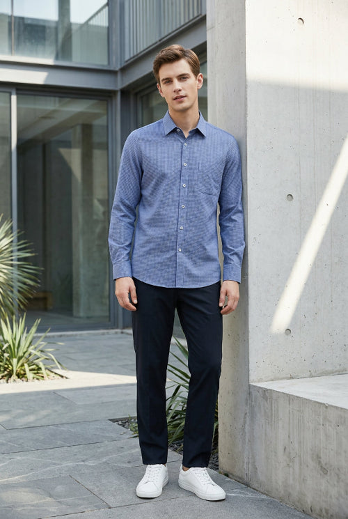 A row of long-sleeve button-up shirts hanging on wooden hangers against a dark gray gradient background. The shirts are shown in multiple colors, including slate 