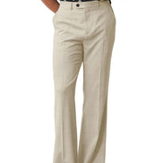 A person wearing high-waisted, wide-leg beige trousers with a subtle textured weave, paired with black sandals and a patterned top, shown against a plain white background.