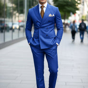 Blue suit with a brown tie and white shirt on a dark background