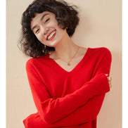 Woman wearing a red sweater with text about warm cashmere on a beige background