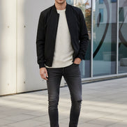 Black slip-on shoes with white soles on a white background