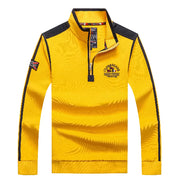 A men's long-sleeve quarter-zip pullover sweatshirt in bright yellow with black shoulder and sleeve stripe accents, a black zipper placket, and printed chest 