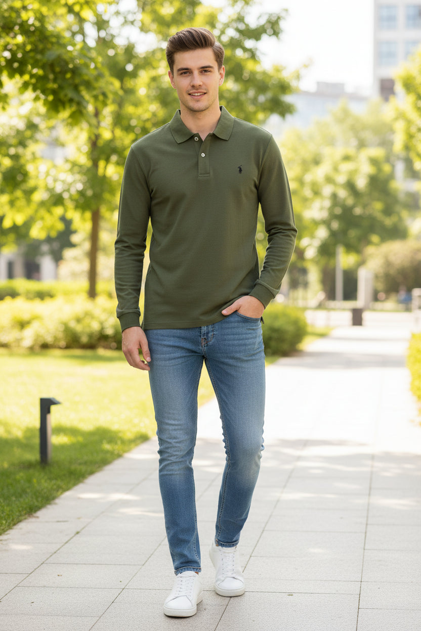Green polo shirt held by a hand with other shirts in the background