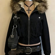 Black jacket with fur hood on a mannequin against a beige background