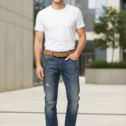 Blue jeans with a brown belt on a white background