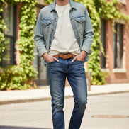 Blue jeans with a brown belt on a white background