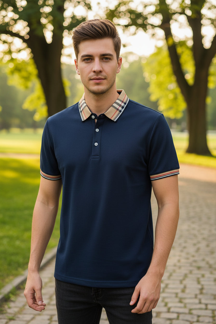 Navy blue polo shirt with plaid collar held by a hand, brand label visible
