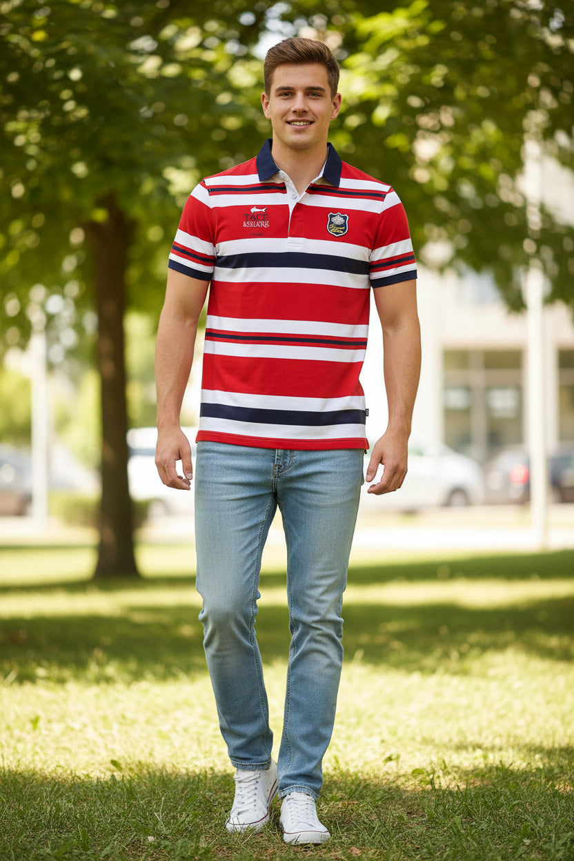 A short-sleeve polo shirt with horizontal red, white, and navy stripes, featuring a navy collar, a two-button placket, and shark-themed graphics including a chest emblem and the TACE&SHARK brand logo on the left chest.