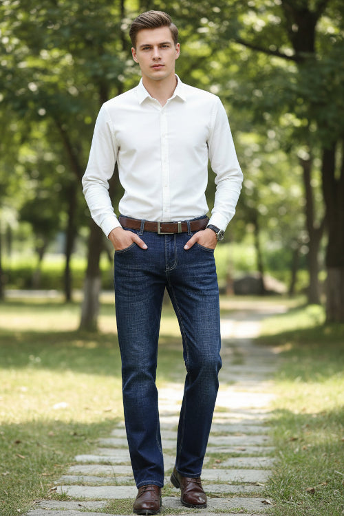 Stack of blue jeans with a person wearing them holding a briefcase.