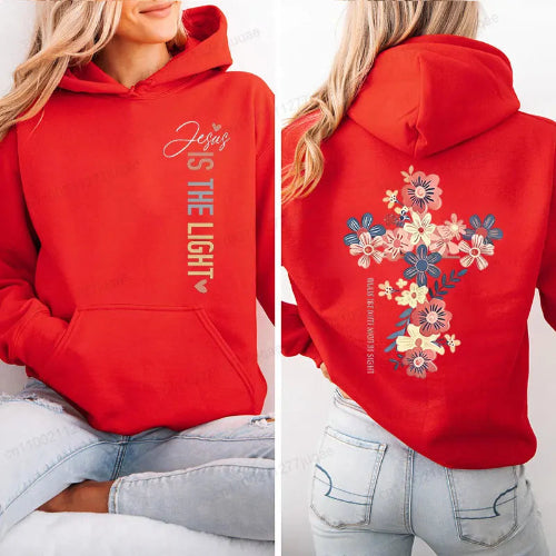 A red pullover hoodie shown on a model from both the front and back. The front features the text 'Jesus IS THE LIGHT' printed vertically in white and gold.