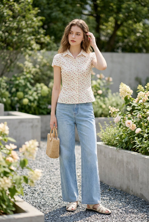 Floral blouse on a hanger against a clothing store background