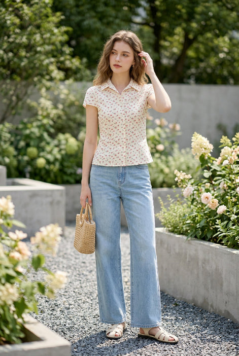 Floral blouse on a hanger against a clothing store background