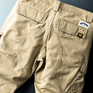 Khaki cargo pants shown flat from the back.