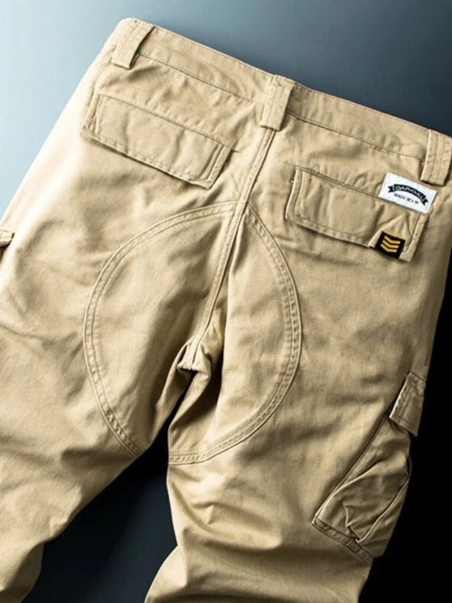 Khaki cargo pants shown flat from the back.