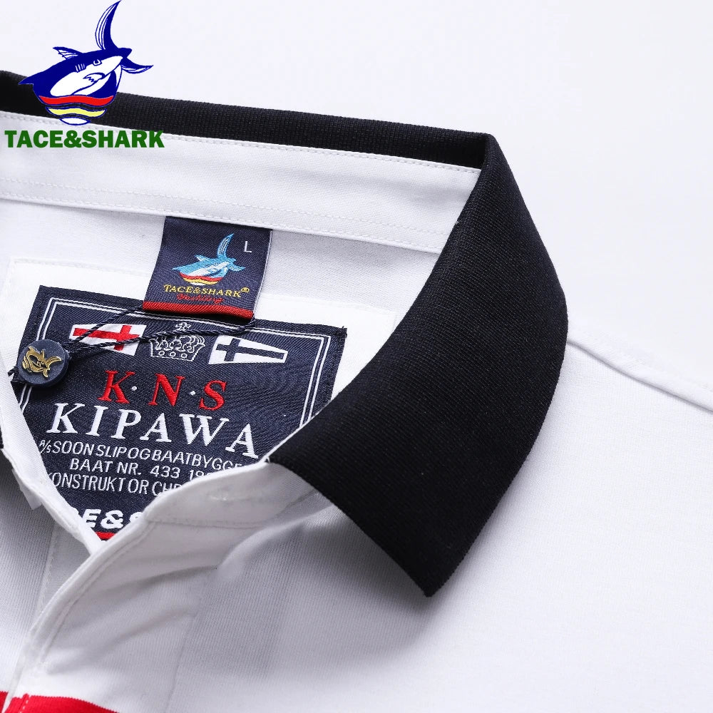 Close-up of a white collared shirt with a black ribbed collar, showing the inner neck labels and a small gold crest pin. The Tace&Shark logo is visible on the collarband and in the top-left corner.