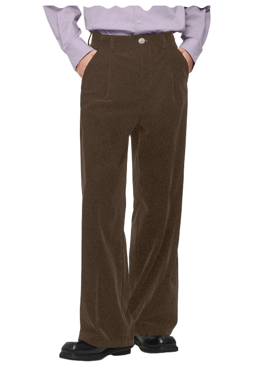 A person wearing high-waisted, wide-leg brown corduroy trousers, styled with a light purple ruffled blouse and black shoes, 