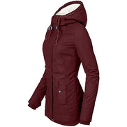 Side view of a burgundy hooded jacket with white fleece-look hood lining, drawstrings and a buttoned front pocket against a white background