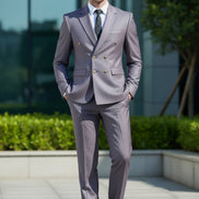 Gray suit with gold buttons worn by a person against a blurred background